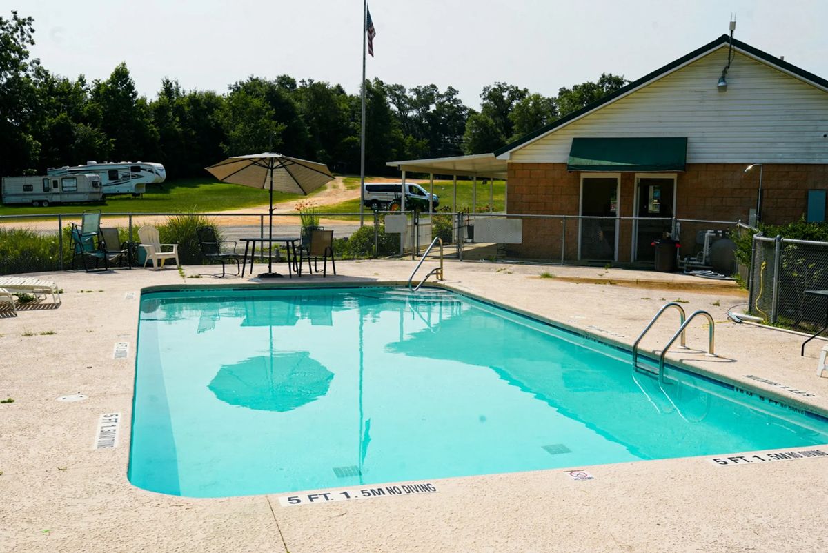 Swimming pool with patio tables next to the park office